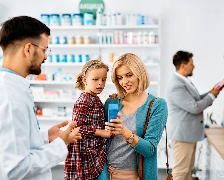 happy-mother-with-daughter-buying-in-a-pharmacy-2023-02-15-23-20-52-utc.jpg