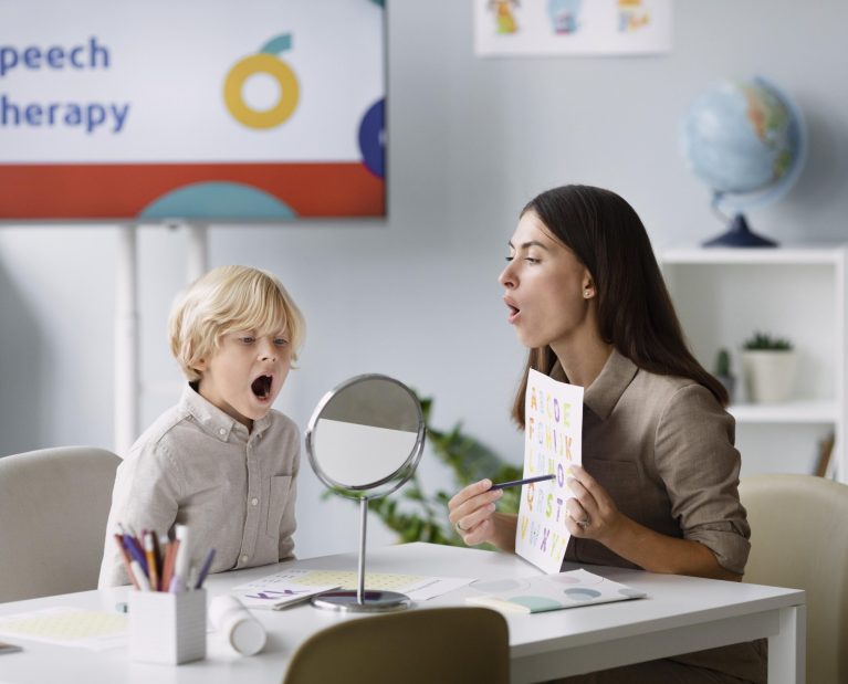 woman-doing-speech-therapy-with-little-boy-her-clinic-scaled.jpg