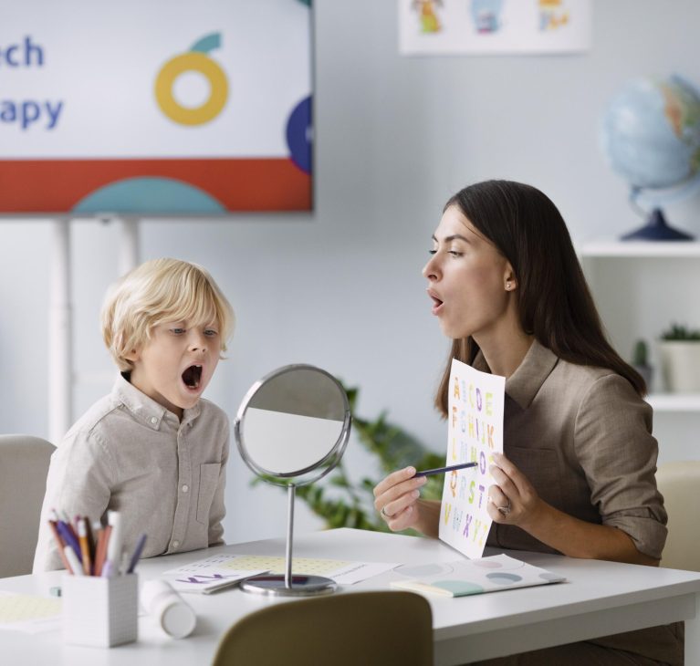 woman-doing-speech-therapy-with-little-boy-her-clinic-scaled.jpg